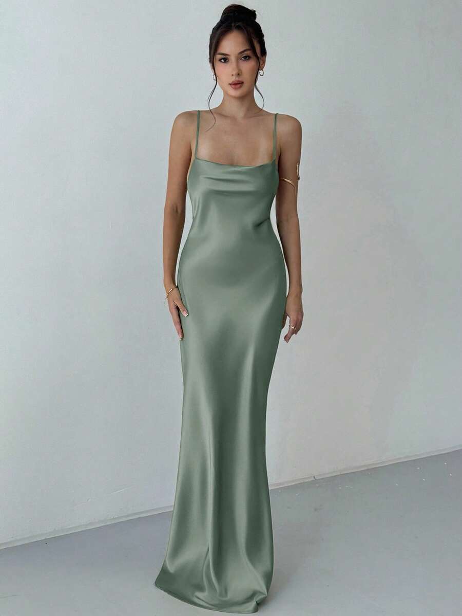 Beige satin backless maxi dress featuring criss-cross spaghetti straps and a mermaid hemline.