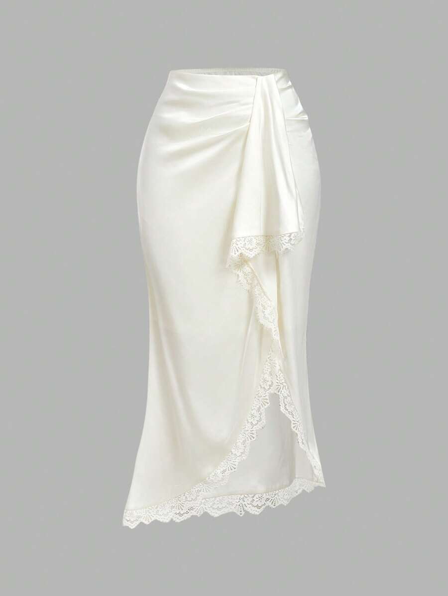Women's elegant pink satin asymmetrical long skirt featuring contrast lace patchwork, ruched knot detailing, and a mid-waist mermaid cut.