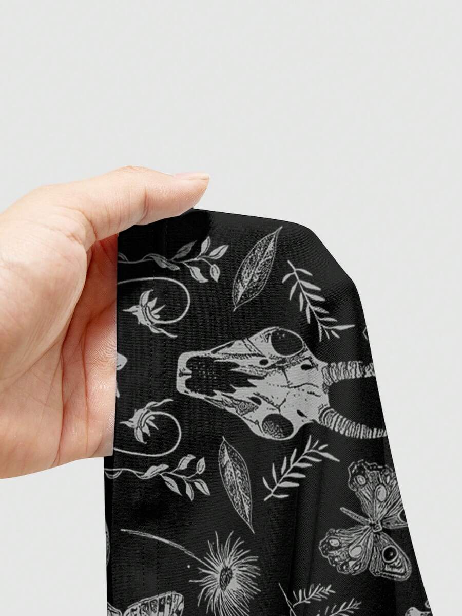 Black rib-knit gothic camisole tank top with a heart skull graphic print, spaghetti straps, and matching separate arm sleeves.