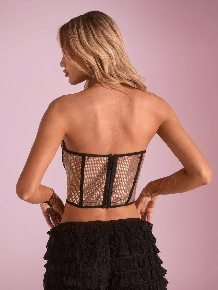 Women's metallic corset crop top in apricot featuring a sweetheart neckline, asymmetrical hem, backless cut, and matching arm sleeves.