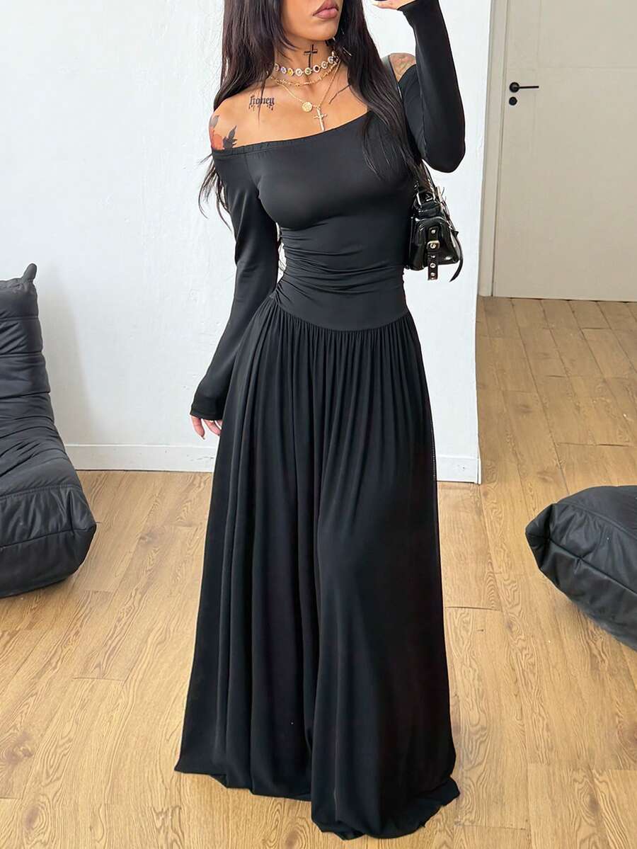 Women wearing a brown off the shoulder maxi dress with asymmetrical ruched cut out details and wrist-length sleeves in a slim fit flared A-line design.