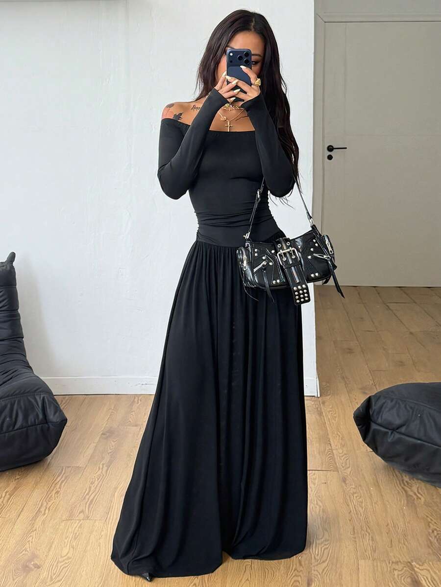 Women wearing a brown off the shoulder maxi dress with asymmetrical ruched cut out details and wrist-length sleeves in a slim fit flared A-line design.
