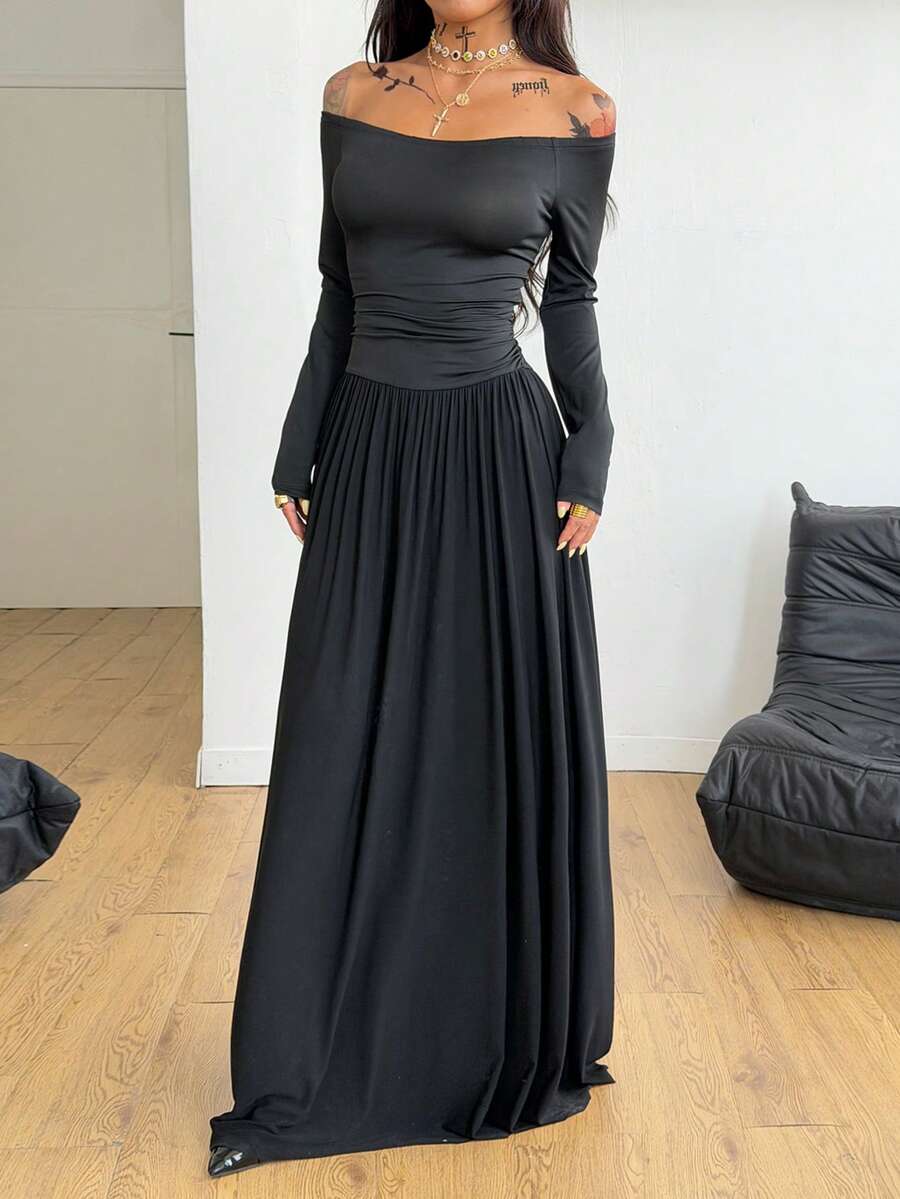 Women wearing a brown off the shoulder maxi dress with asymmetrical ruched cut out details and wrist-length sleeves in a slim fit flared A-line design.