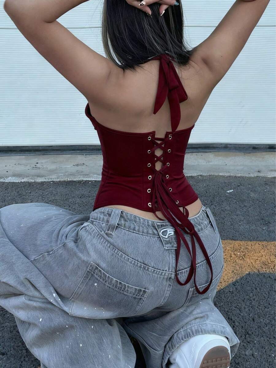 White satin corset crop top featuring a halter neck, slim fit, and back lace-up design.