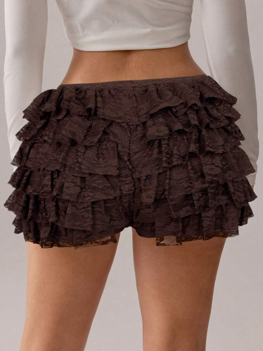 Apricot tiered lace ruffle hem low waist shorts for women featuring elastic waist and lined semi-sheer knit fabric.