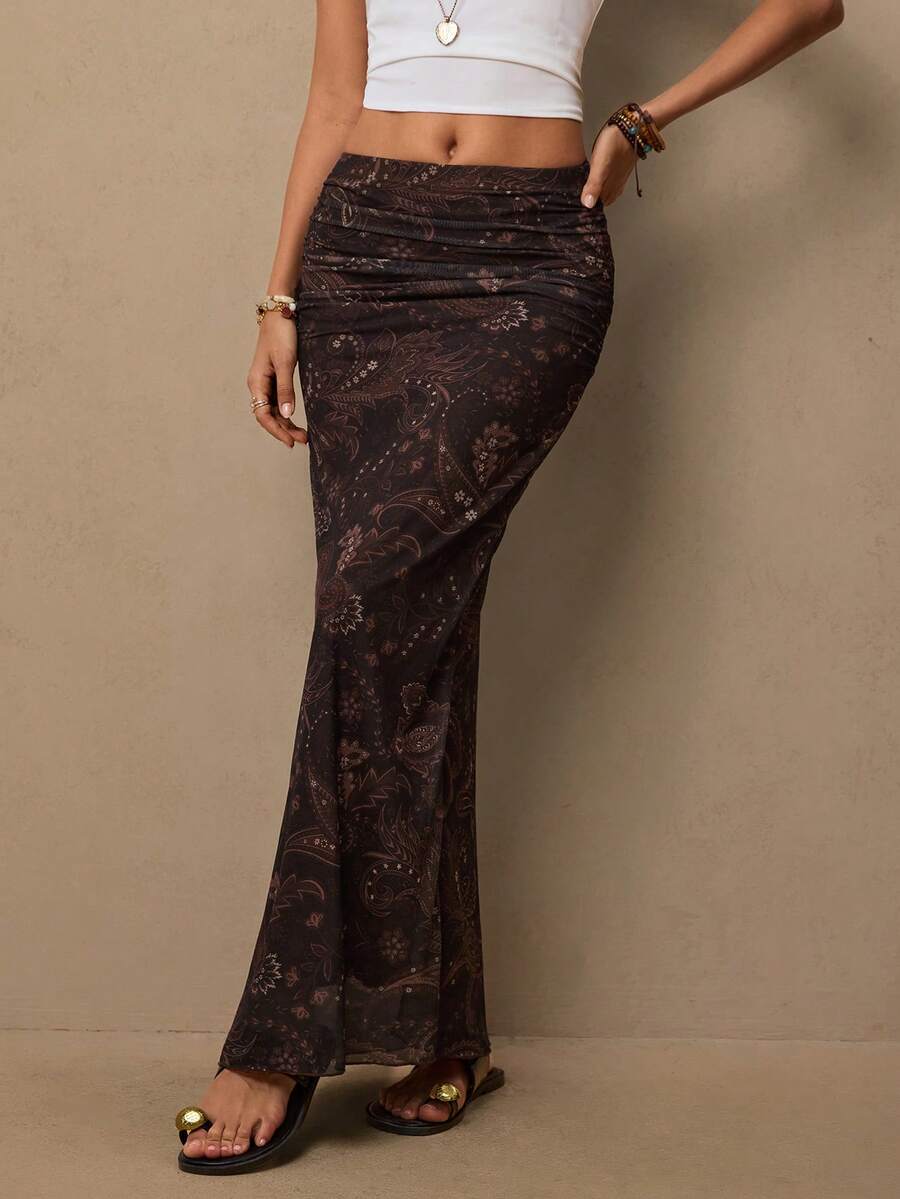 Women's brown bohemian retro paisley print knit maxi skirt featuring a high waist, ruched detailing, and side slit.