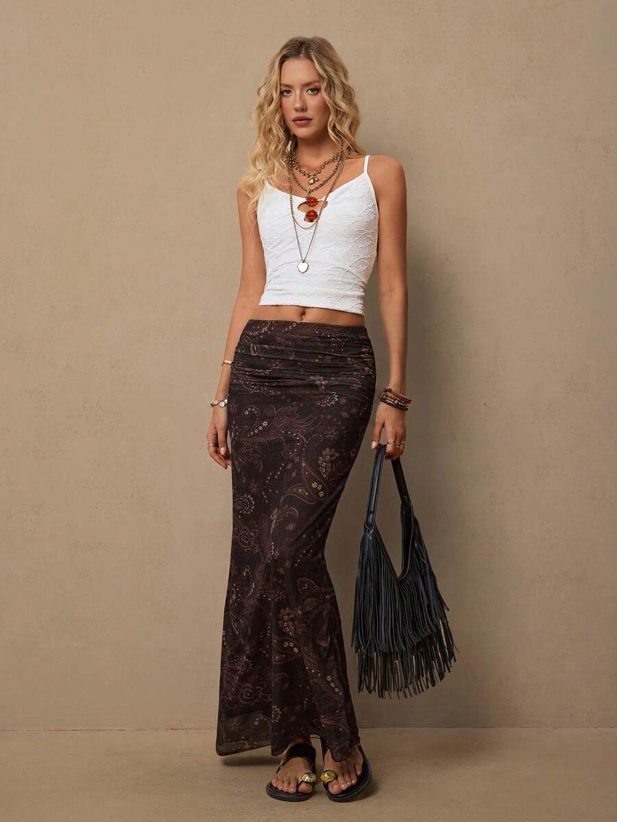 Women's brown bohemian retro paisley print knit maxi skirt featuring a high waist, ruched detailing, and side slit.