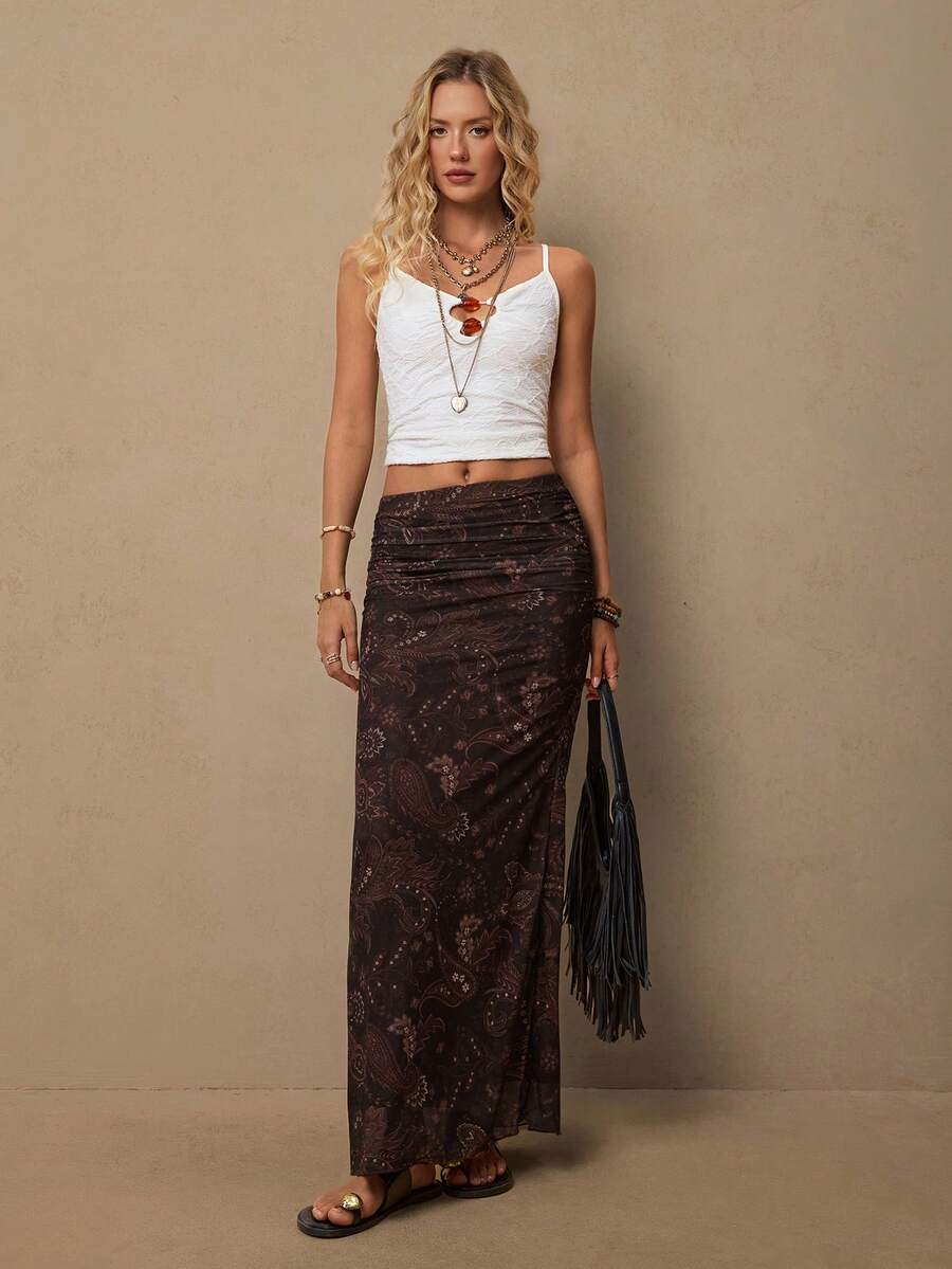 Women's brown bohemian retro paisley print knit maxi skirt featuring a high waist, ruched detailing, and side slit.
