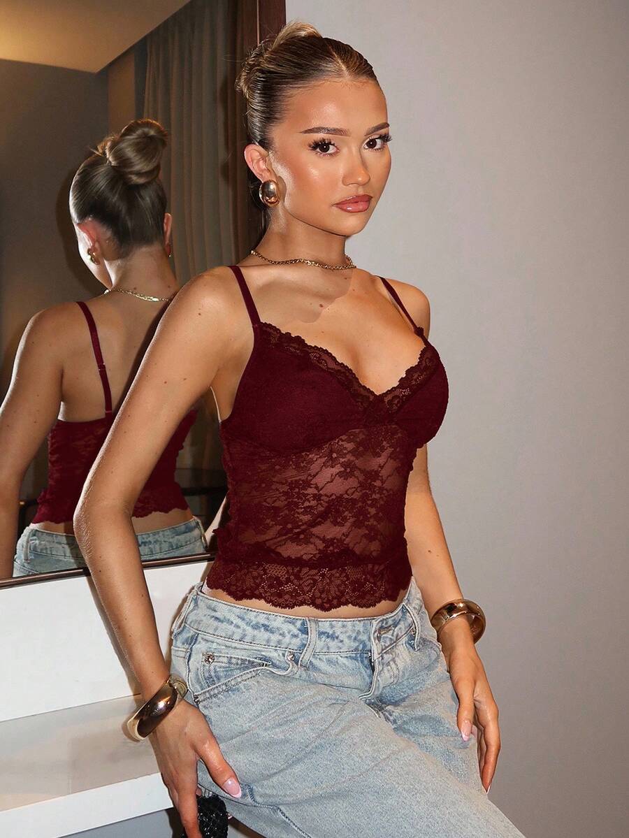Black floral lace cropped camisole top for women featuring delicate spaghetti straps, cup detail, and semi-sheer contrast lace.