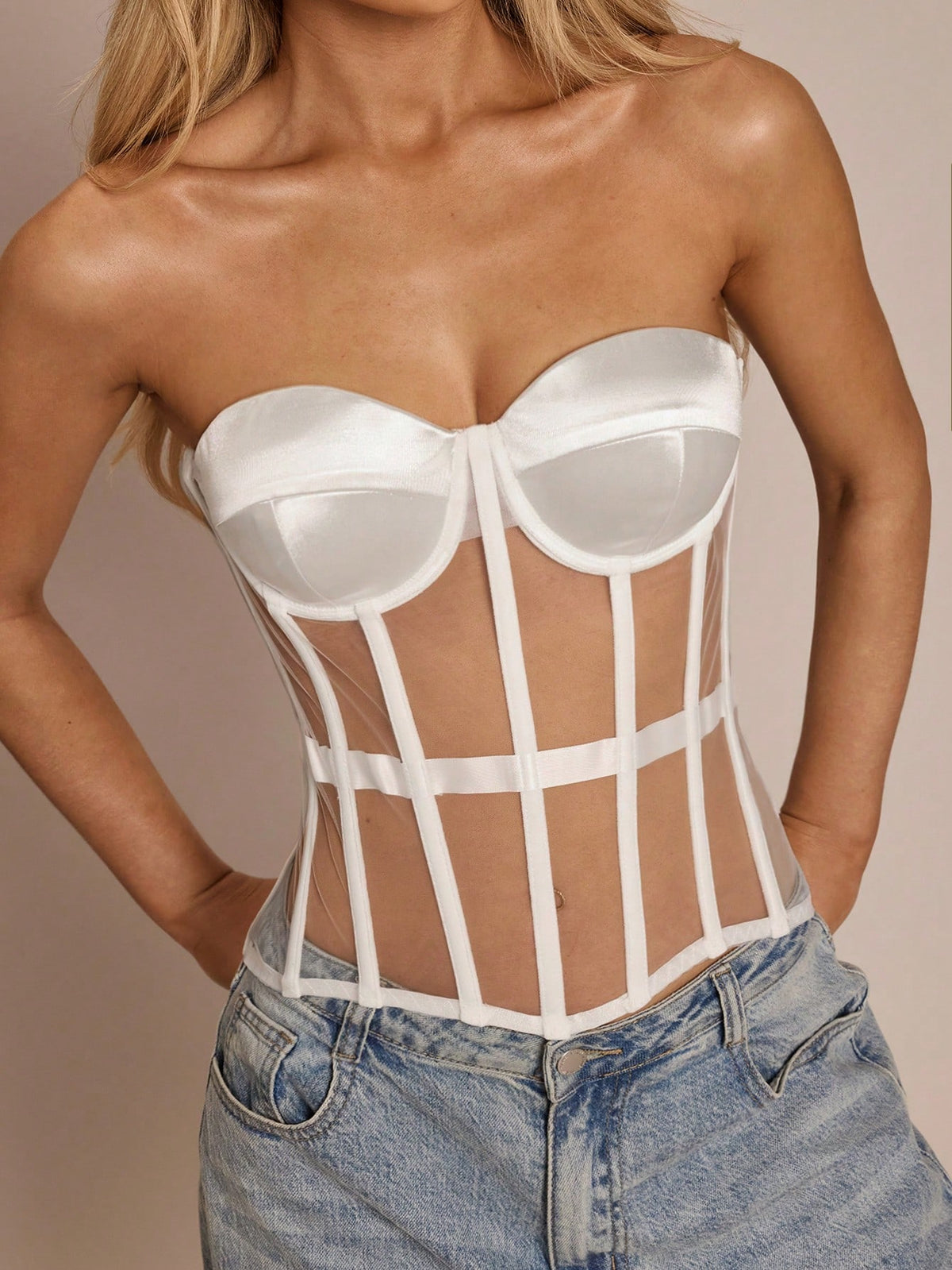 Women's black mesh patchwork bustier corset crop top with sweetheart neckline and asymmetrical hem.