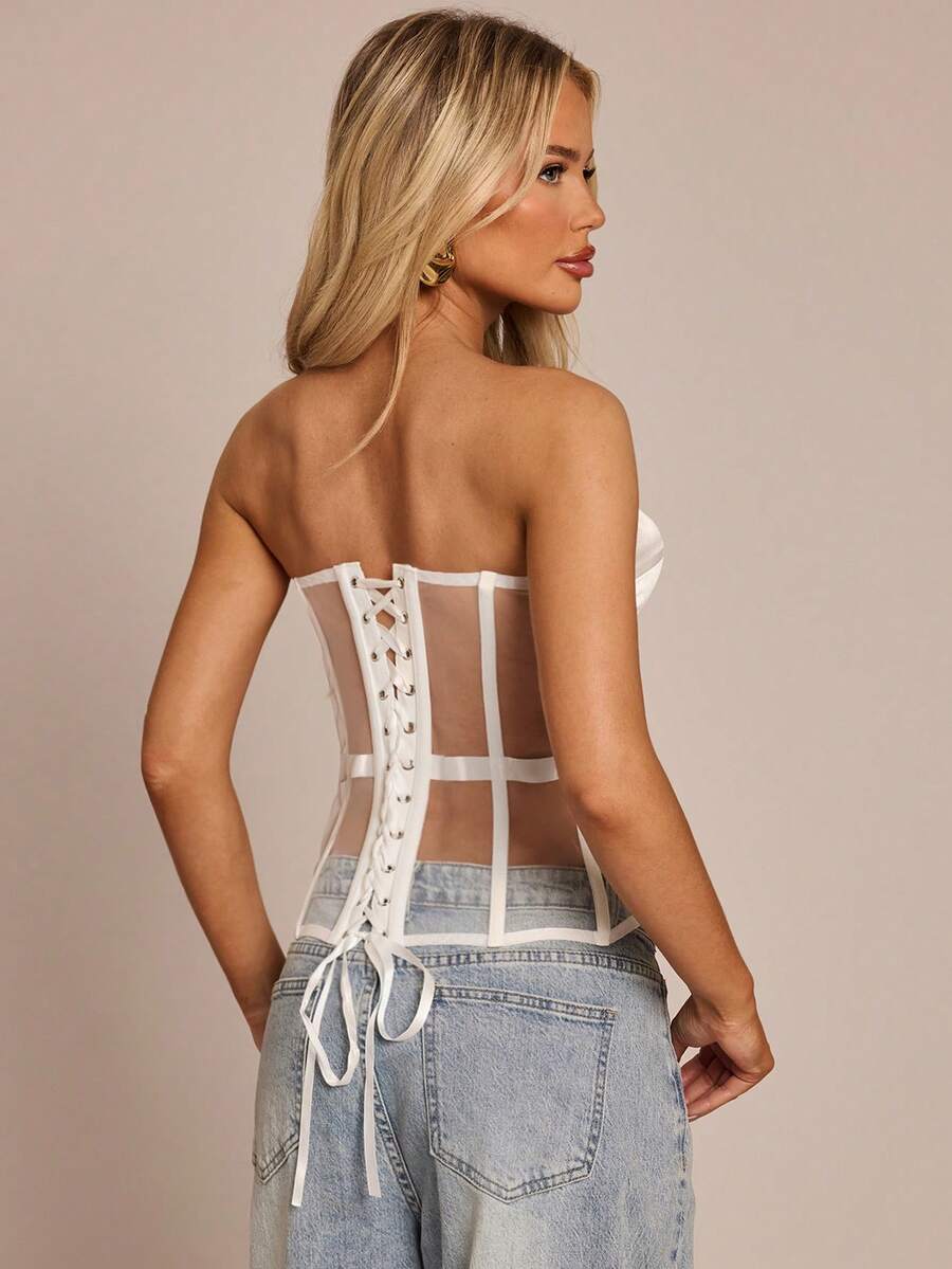 Women's black mesh patchwork bustier corset crop top with sweetheart neckline and asymmetrical hem.