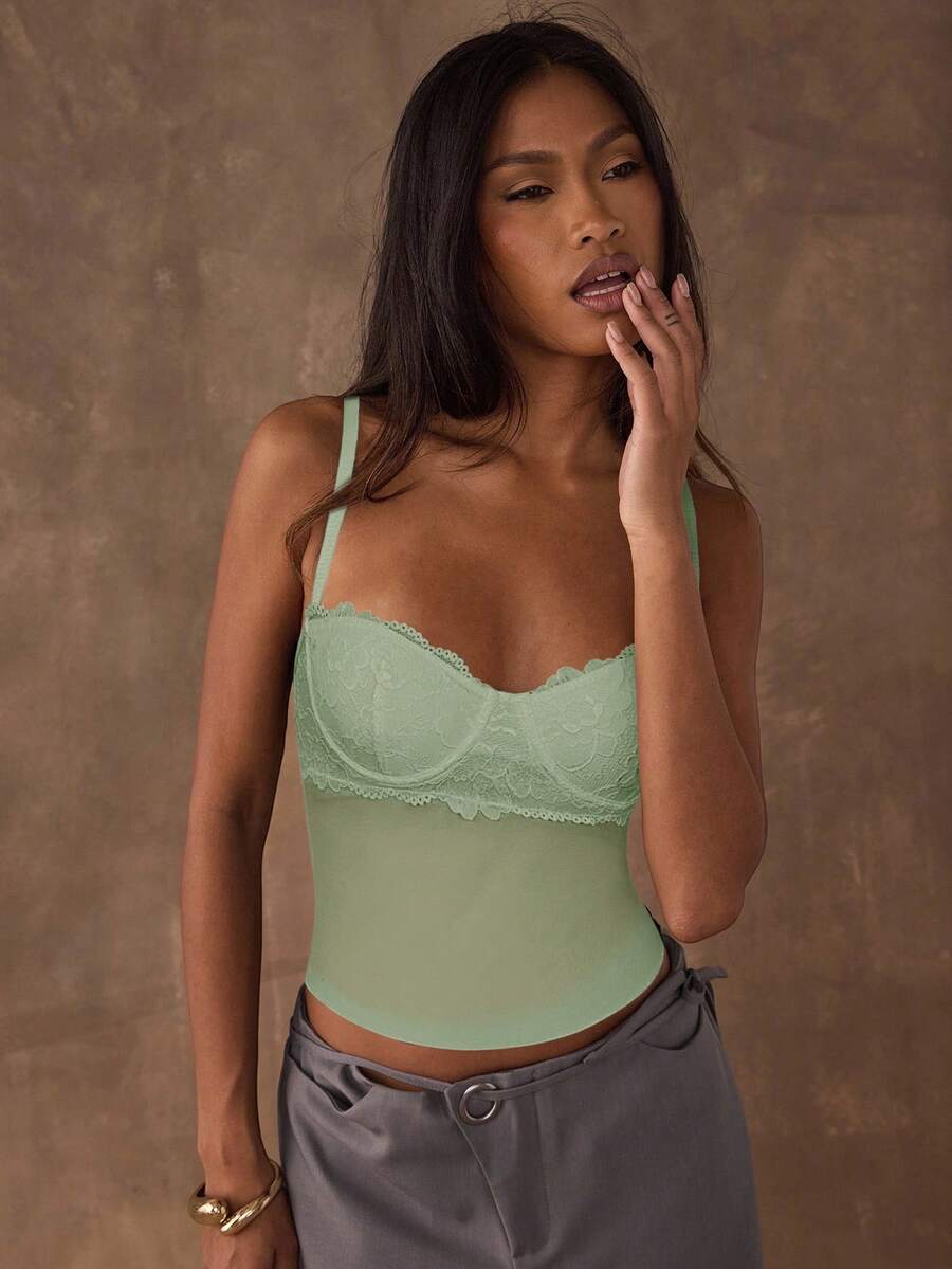Women's black contrast lace camisole with spaghetti straps, cup detail, semi-sheer finish, and slim fit for going out or date night.