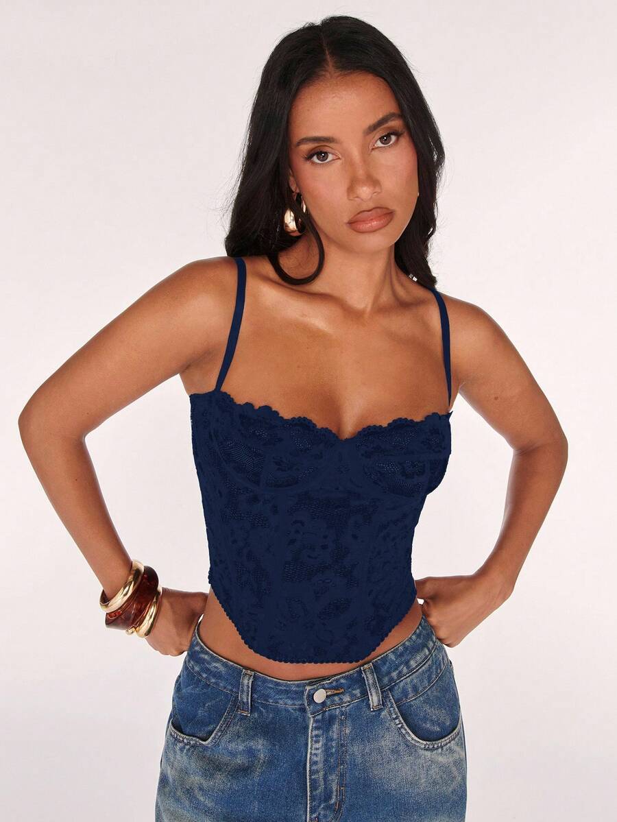 Black women’s lace cami top with spaghetti straps, contrast lace details, and an asymmetrical hem, styled as a slim-fit lined casual top.