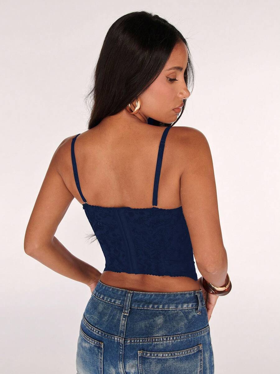 Black women’s lace cami top with spaghetti straps, contrast lace details, and an asymmetrical hem, styled as a slim-fit lined casual top.