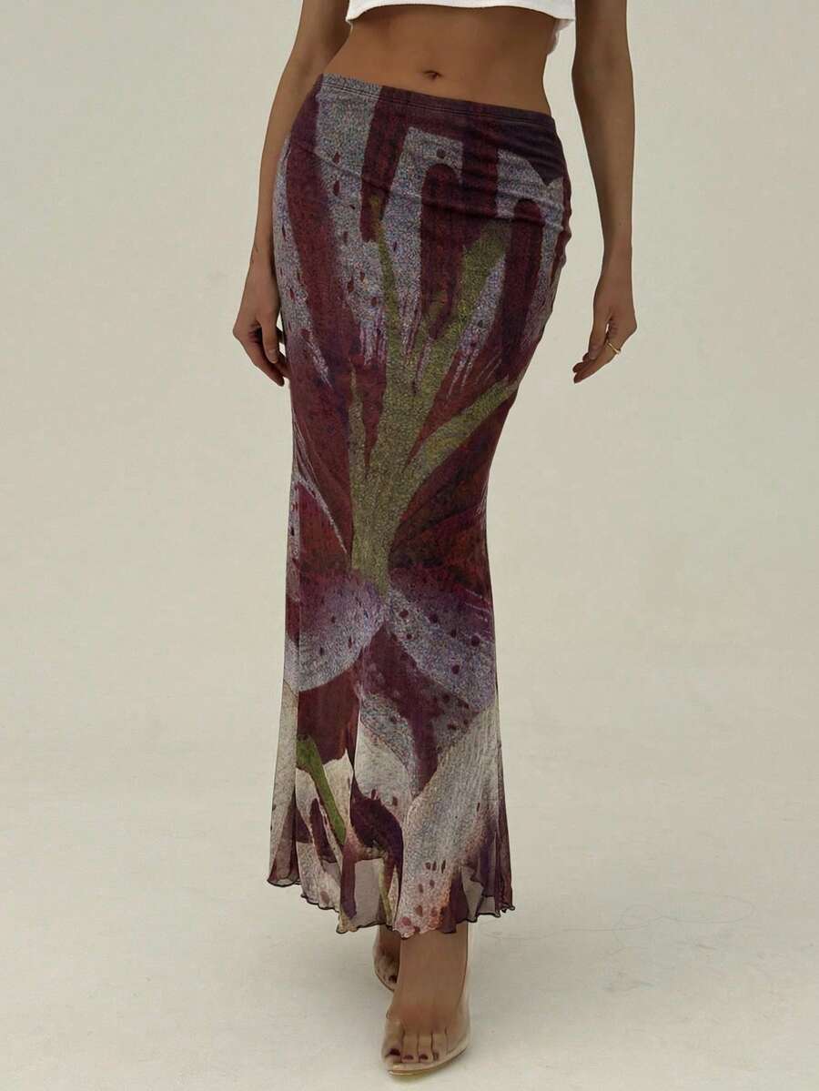Black floral print mesh maxi skirt for women featuring high waist, ruched asymmetrical design, lettuce trim, and mermaid hem.