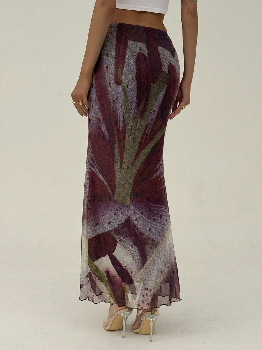Black floral print mesh maxi skirt for women featuring high waist, ruched asymmetrical design, lettuce trim, and mermaid hem.