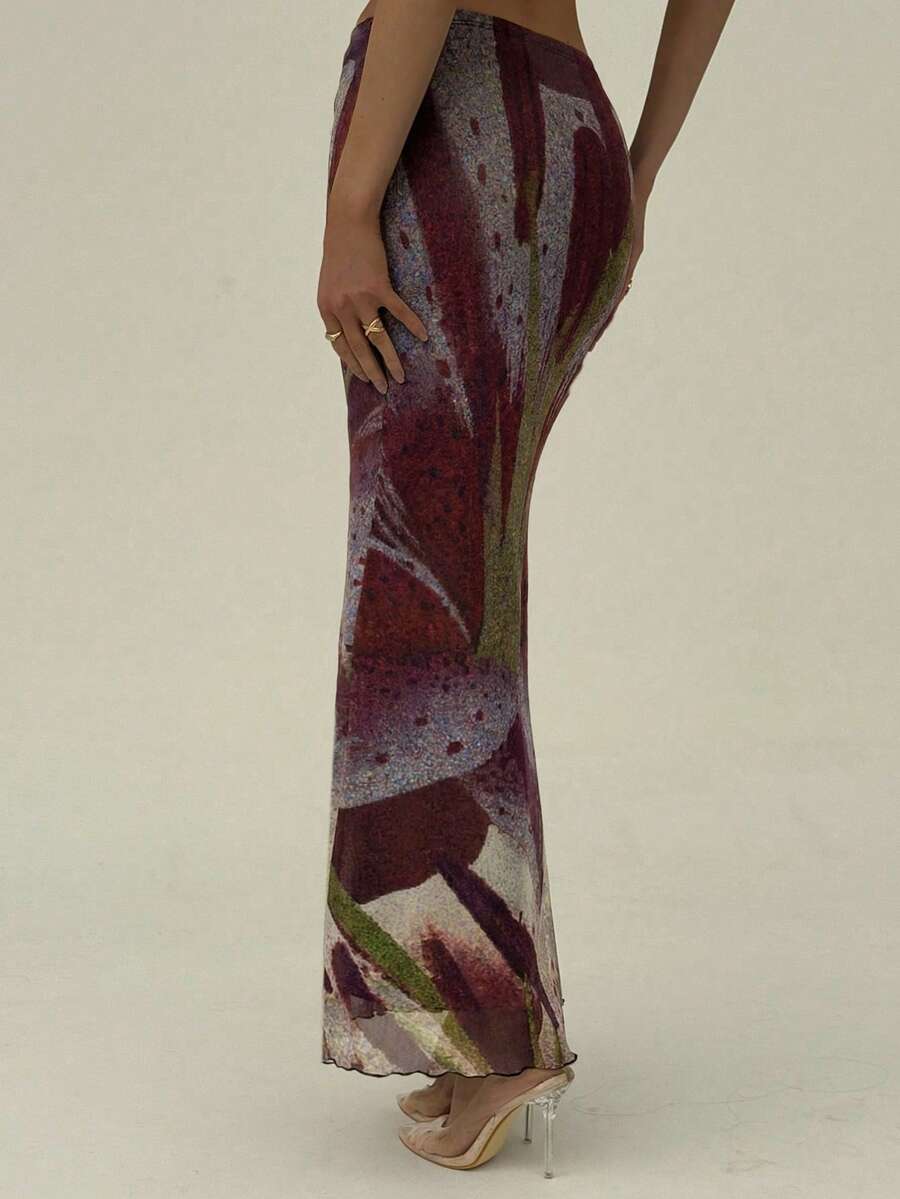 Black floral print mesh maxi skirt for women featuring high waist, ruched asymmetrical design, lettuce trim, and mermaid hem.