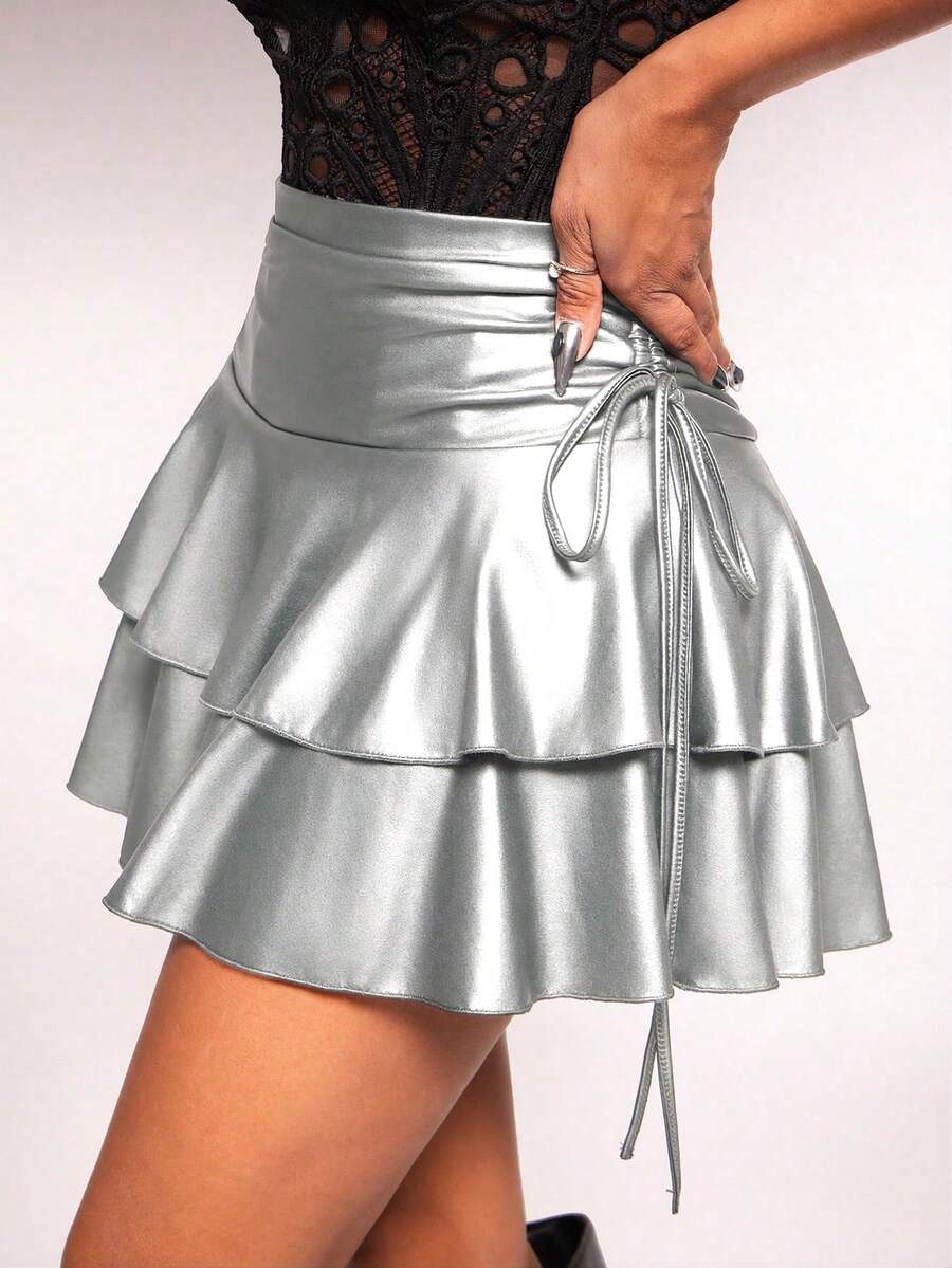 Women's black PU coated layered ruffle mini skirt featuring a high waist, tiered ruffle hem, and zipper detail.