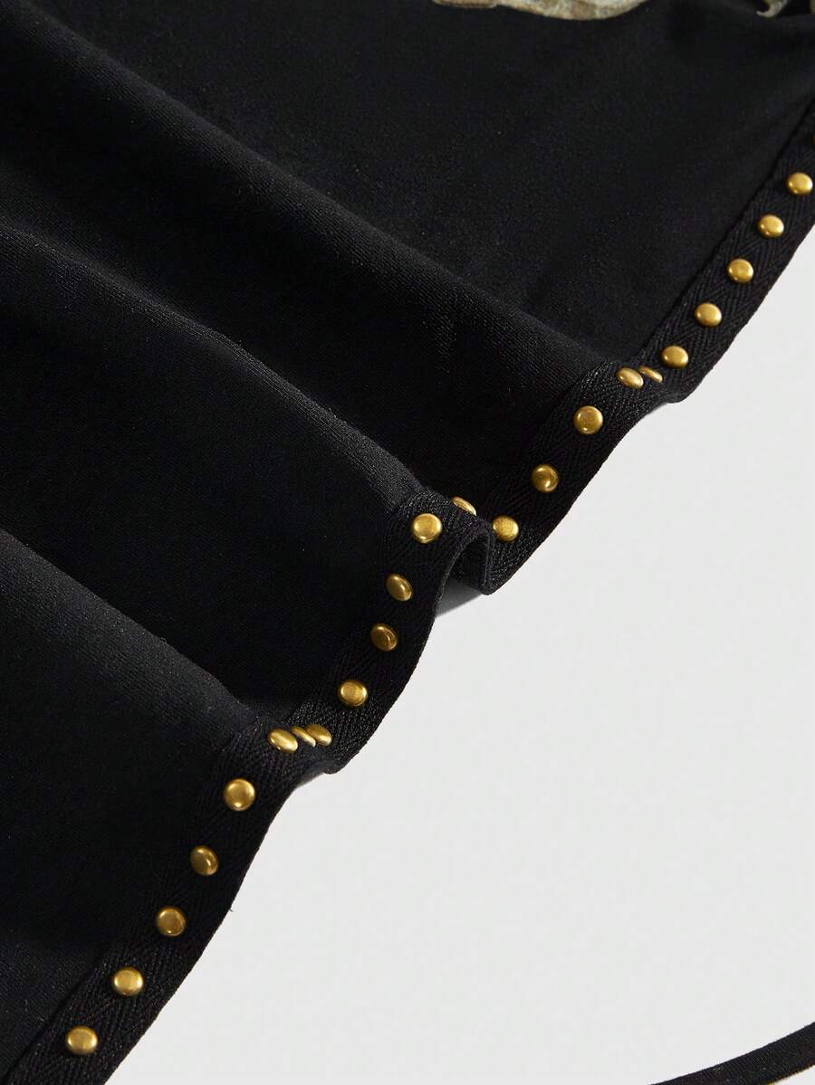 Women's black backless halter crop top featuring a V-neckline, tie-back detail, and asymmetrical hem.