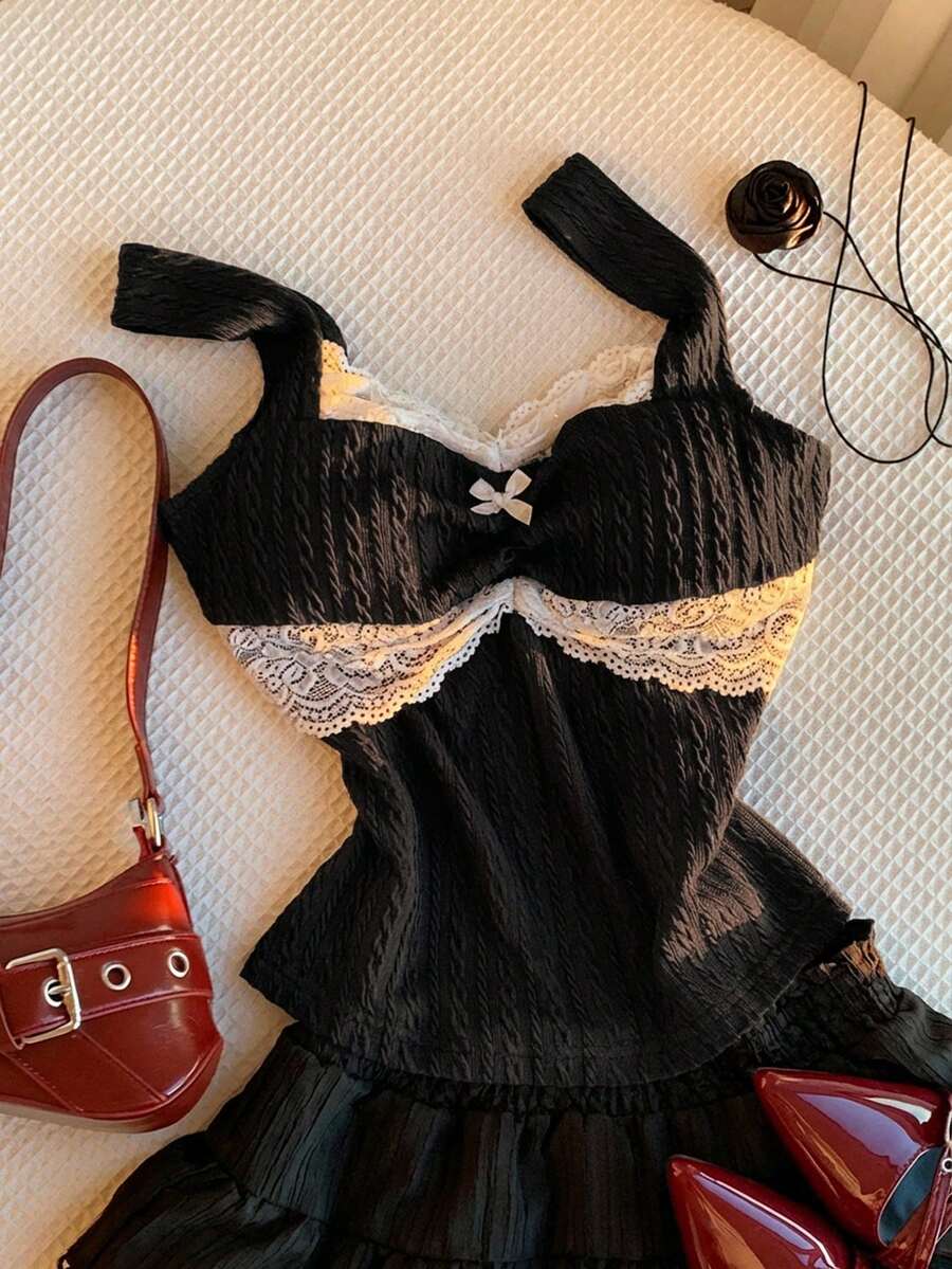 Black and white polka dot knit camisole tank top featuring delicate contrast lace trim, a cute bow accent at the sweetheart neckline, and slender shoulder straps.