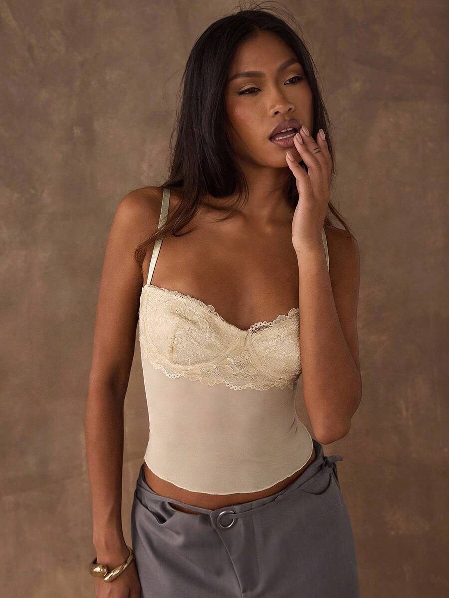 Women's black contrast lace camisole with spaghetti straps, cup detail, semi-sheer finish, and slim fit for going out or date night.