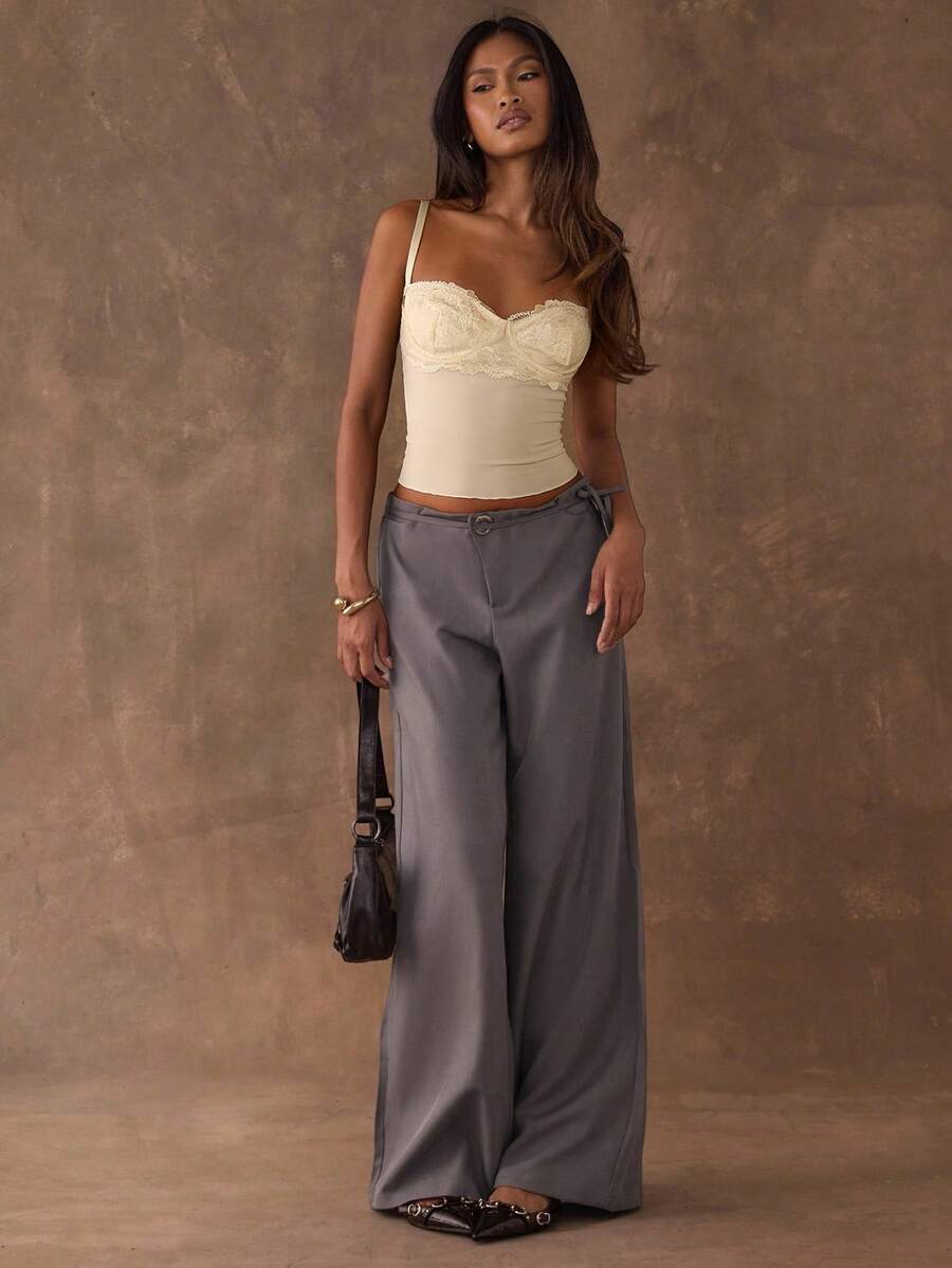 Women's black contrast lace camisole with spaghetti straps, cup detail, semi-sheer finish, and slim fit for going out or date night.
