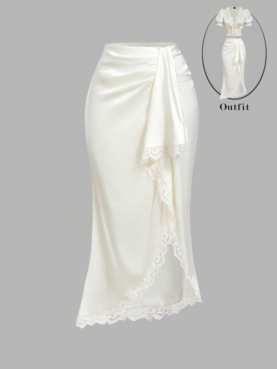 Women's elegant pink satin asymmetrical long skirt featuring contrast lace patchwork, ruched knot detailing, and a mid-waist mermaid cut.
