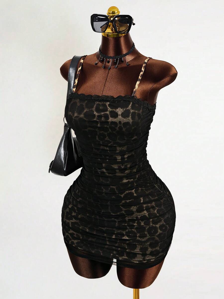 Black sleeveless mesh cami mini dress featuring spaghetti straps and slim fit design for women.