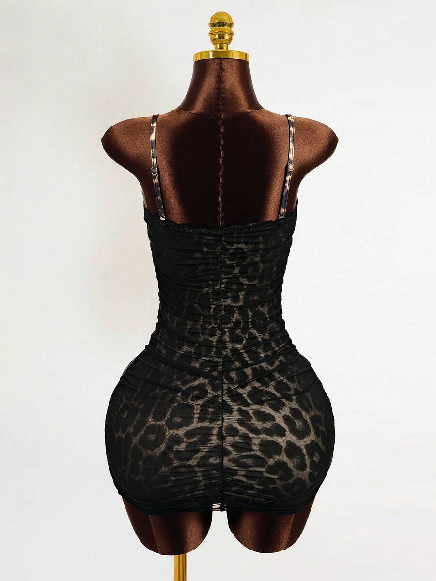 Black sleeveless mesh cami mini dress featuring spaghetti straps and slim fit design for women.