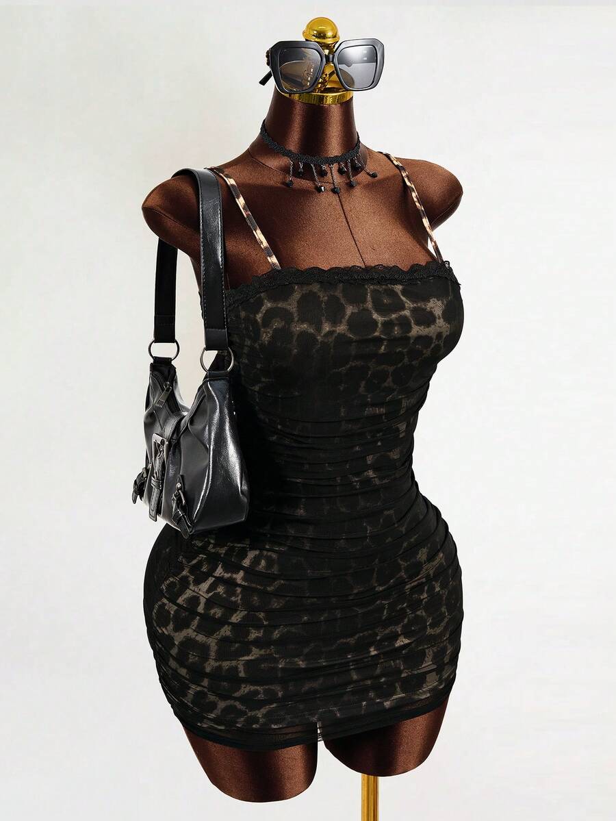 Black sleeveless mesh cami mini dress featuring spaghetti straps and slim fit design for women.