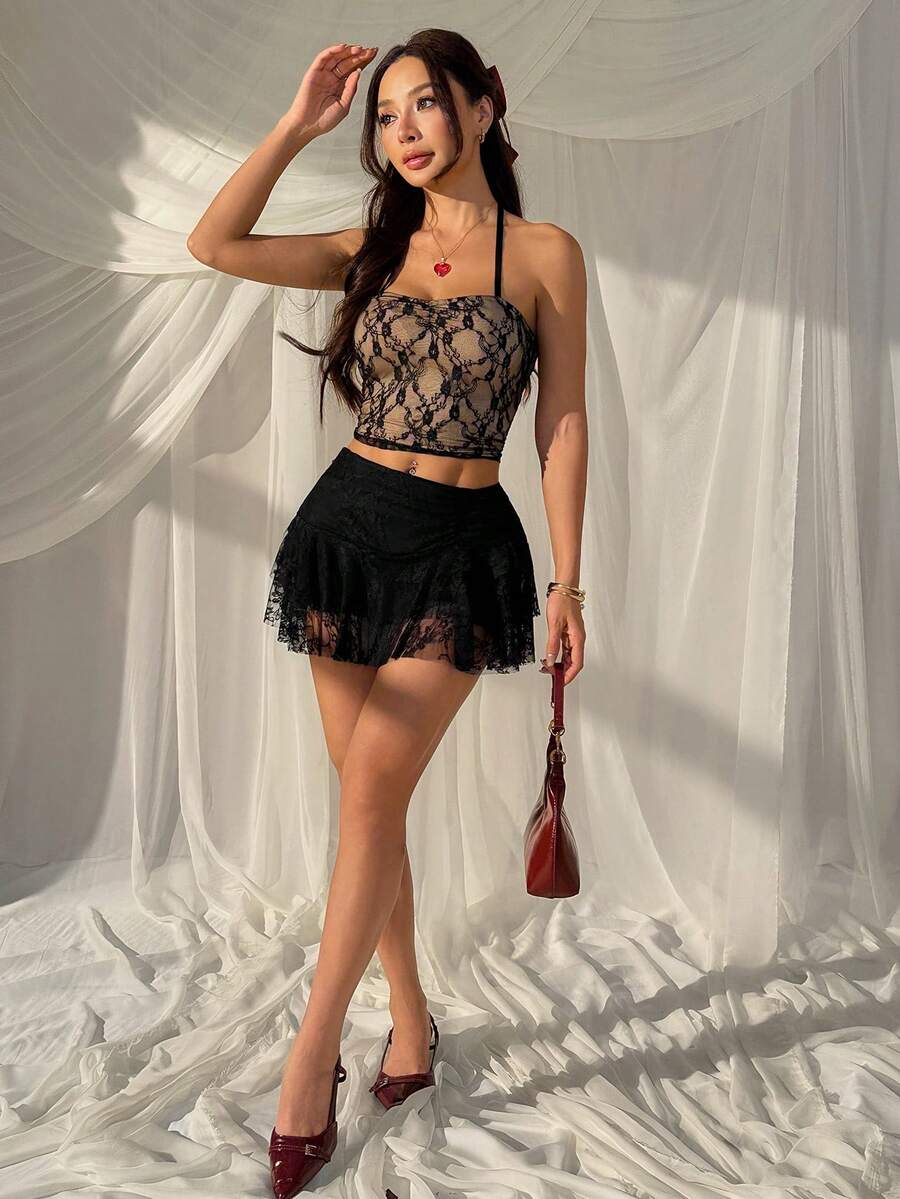 Black tiered ruffle mini cake skirt for women featuring a mid-waist pleated design and layered ruffle hem.