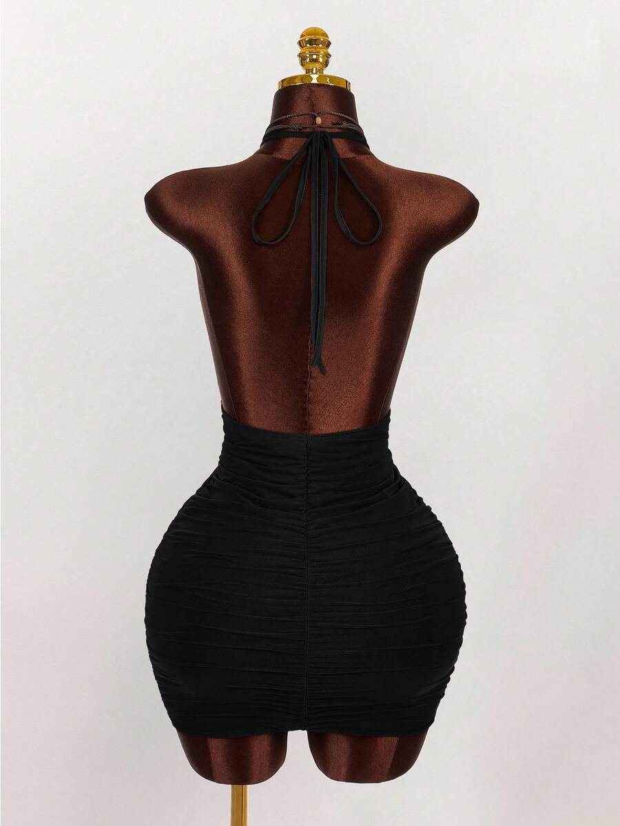 Women's black halter mini dress featuring a backless draped design, semi-sheer mesh fabric, and slim pencil fit.