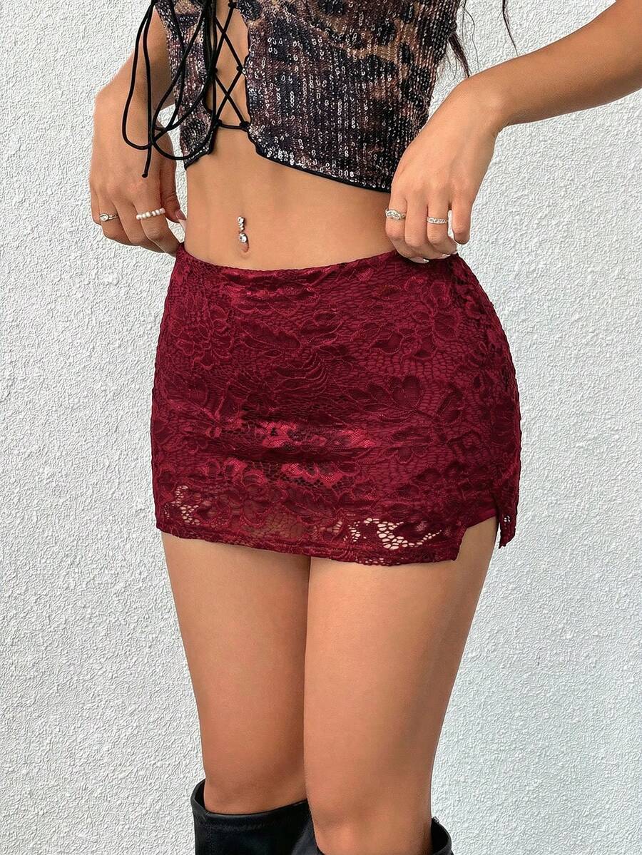 Women's black low waist bodycon mini skirt featuring contrast lace trim, side split detail, and zipper closure.