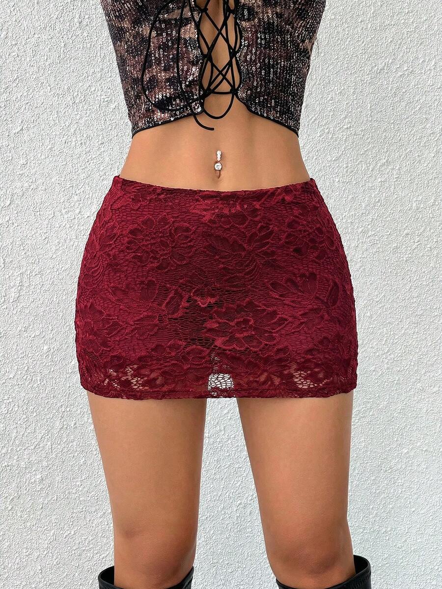 Women's black low waist bodycon mini skirt featuring contrast lace trim, side split detail, and zipper closure.