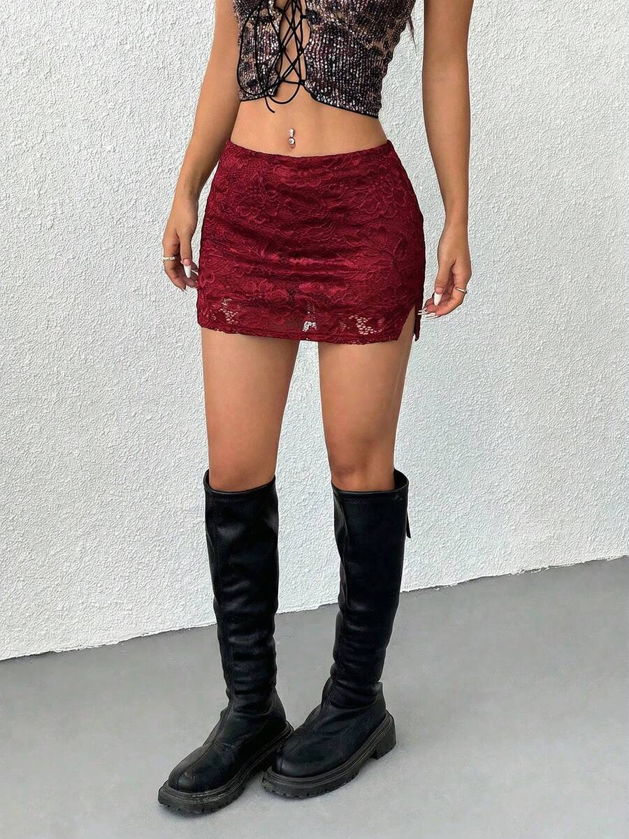 Women's black low waist bodycon mini skirt featuring contrast lace trim, side split detail, and zipper closure.