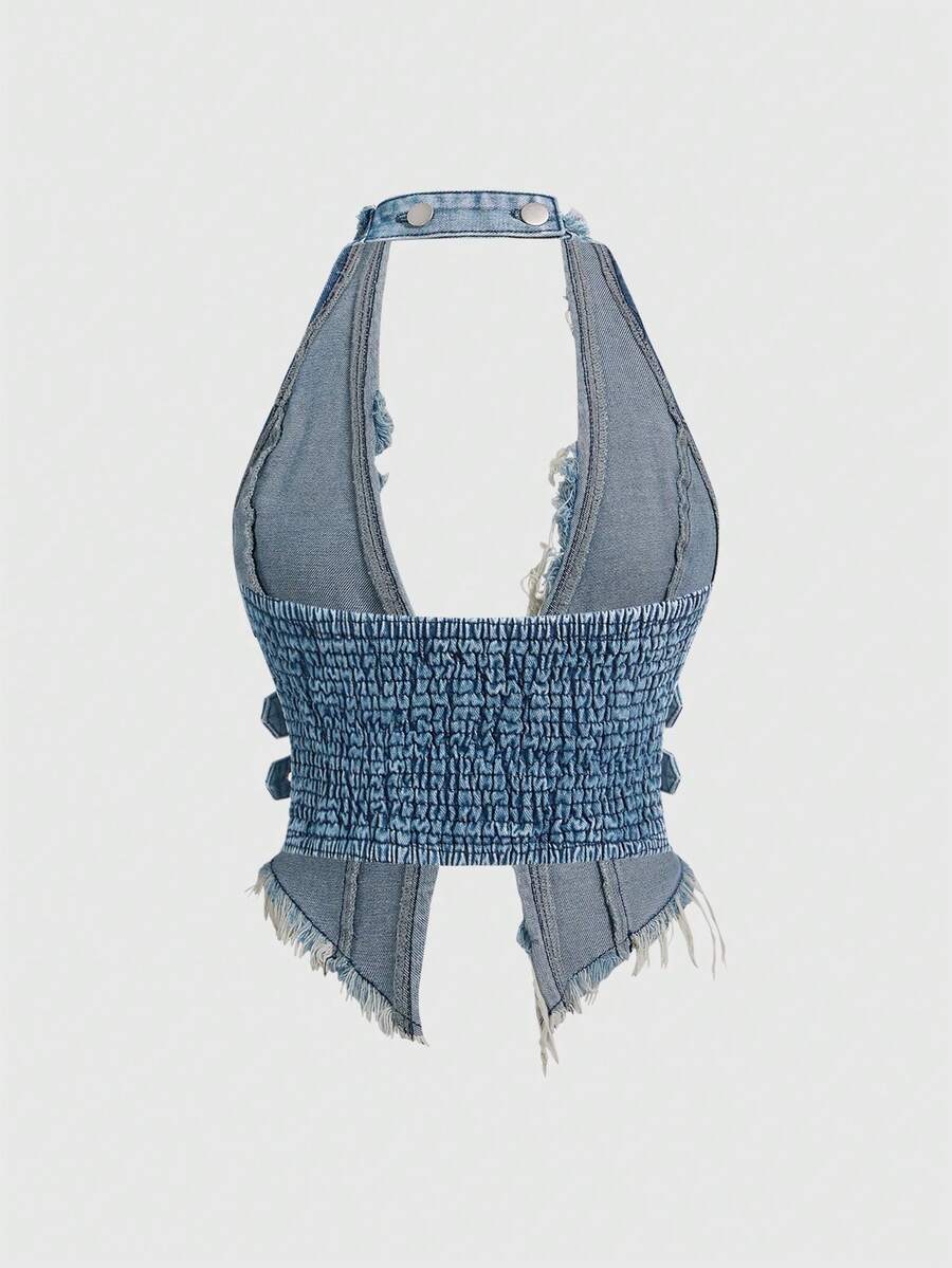 Women's denim halter crop top featuring a backless design, asymmetrical hem, single-breasted front, and lettuce trim.