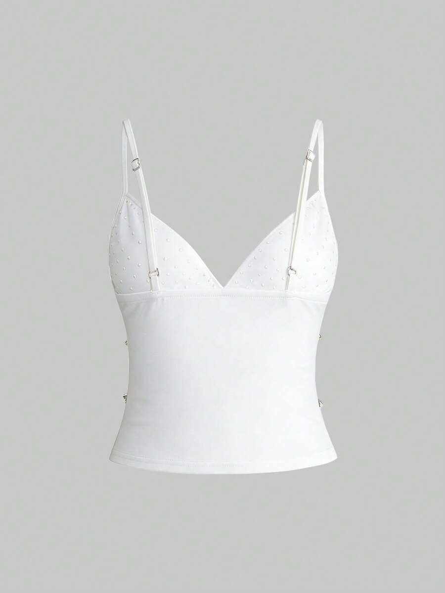 Front view of a black women's dark grunge camisole top featuring rivet studs, rhinestones, sequin details, spaghetti straps, and a slim fit.