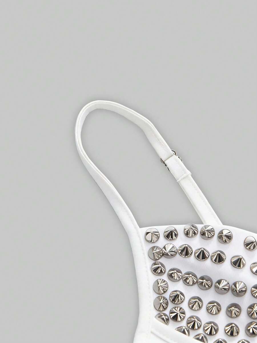 Front view of a black women's dark grunge camisole top featuring rivet studs, rhinestones, sequin details, spaghetti straps, and a slim fit.