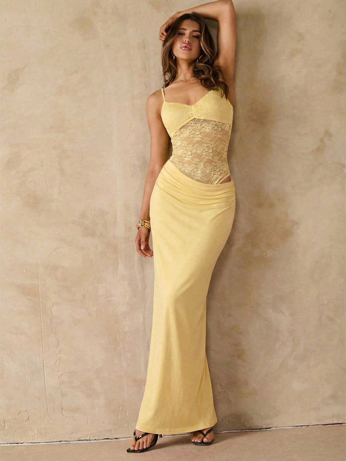 Women's black backless lace patchwork maxi dress with spaghetti straps and mermaid hem.