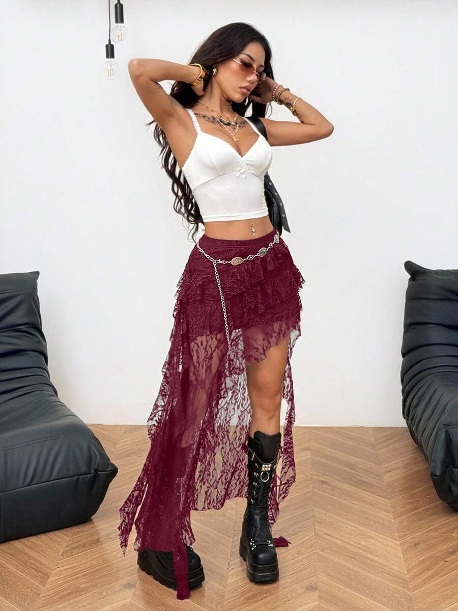 Women's black asymmetrical long skirt with ruffle hem and low waist design in knitted fabric.