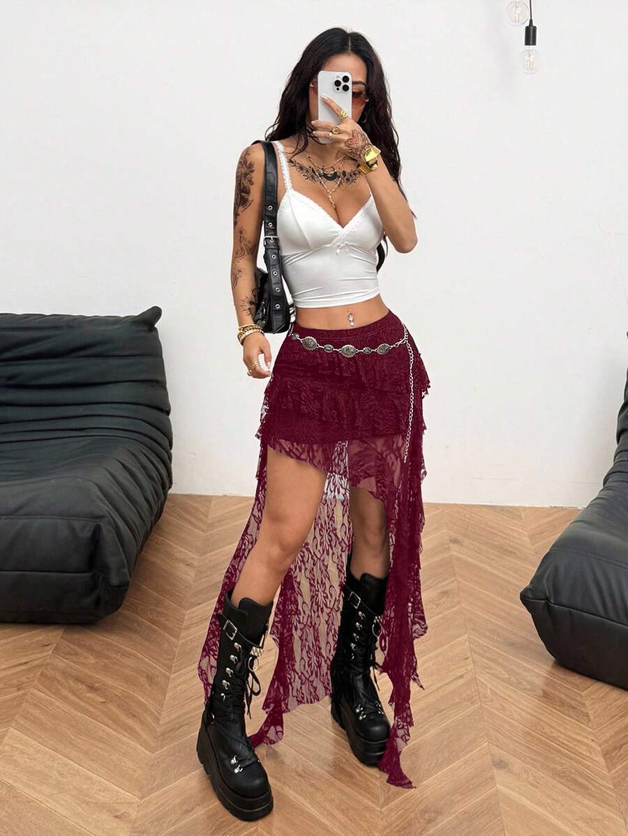 Women's black asymmetrical long skirt with ruffle hem and low waist design in knitted fabric.