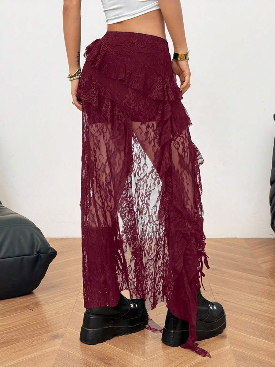 Women's black asymmetrical long skirt with ruffle hem and low waist design in knitted fabric.