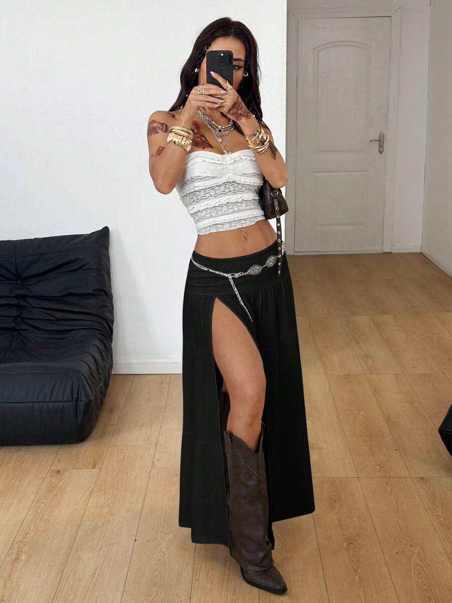 Women's black low waist split thigh long skirt featuring semi-sheer textured fabric and a flared skinny fit.