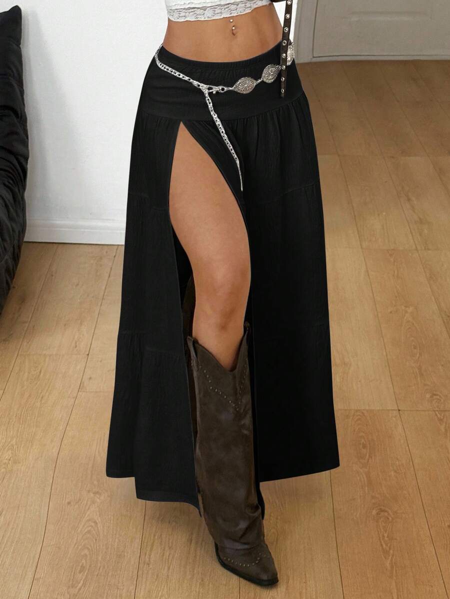 Women's black low waist split thigh long skirt featuring semi-sheer textured fabric and a flared skinny fit.