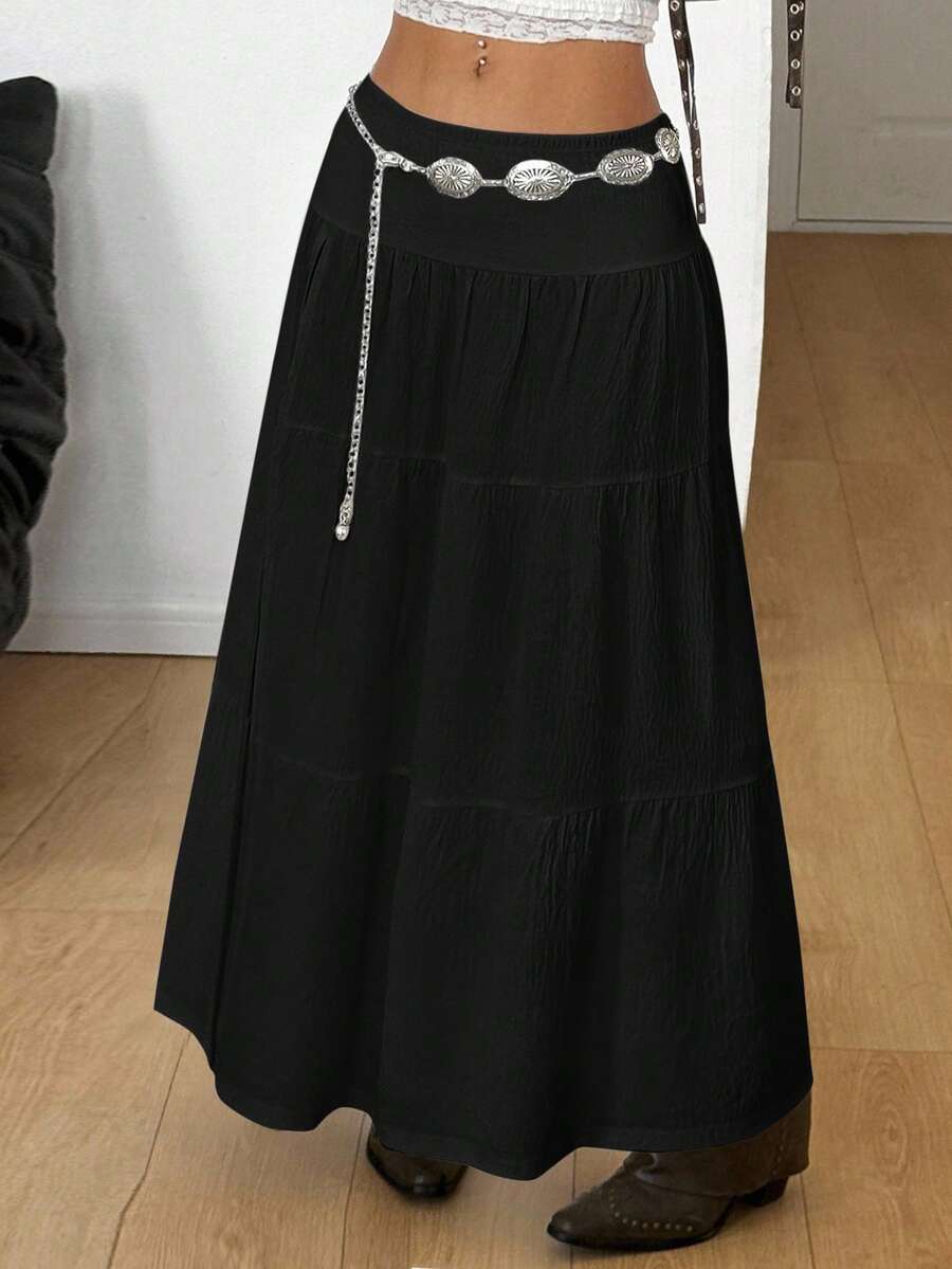 Women's black low waist split thigh long skirt featuring semi-sheer textured fabric and a flared skinny fit.