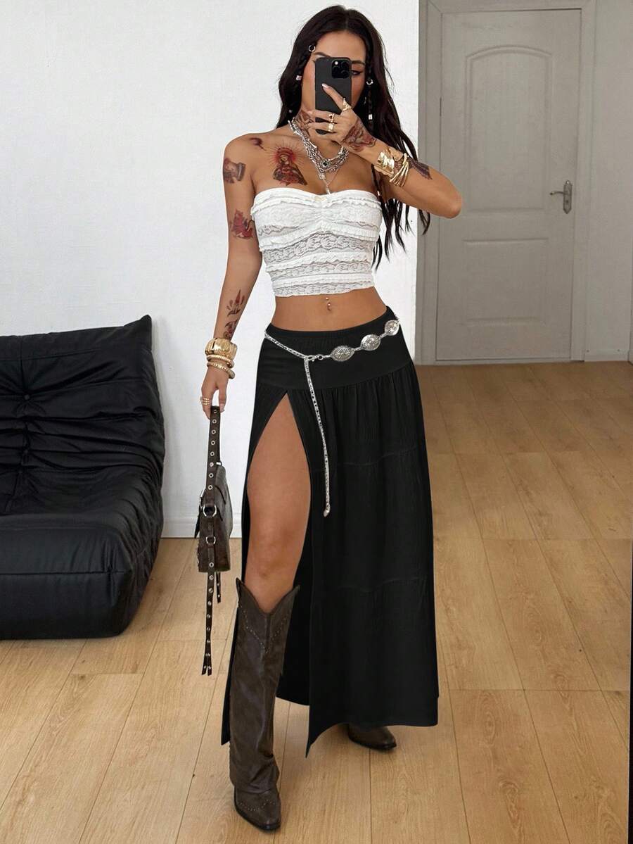 Women's black low waist split thigh long skirt featuring semi-sheer textured fabric and a flared skinny fit.