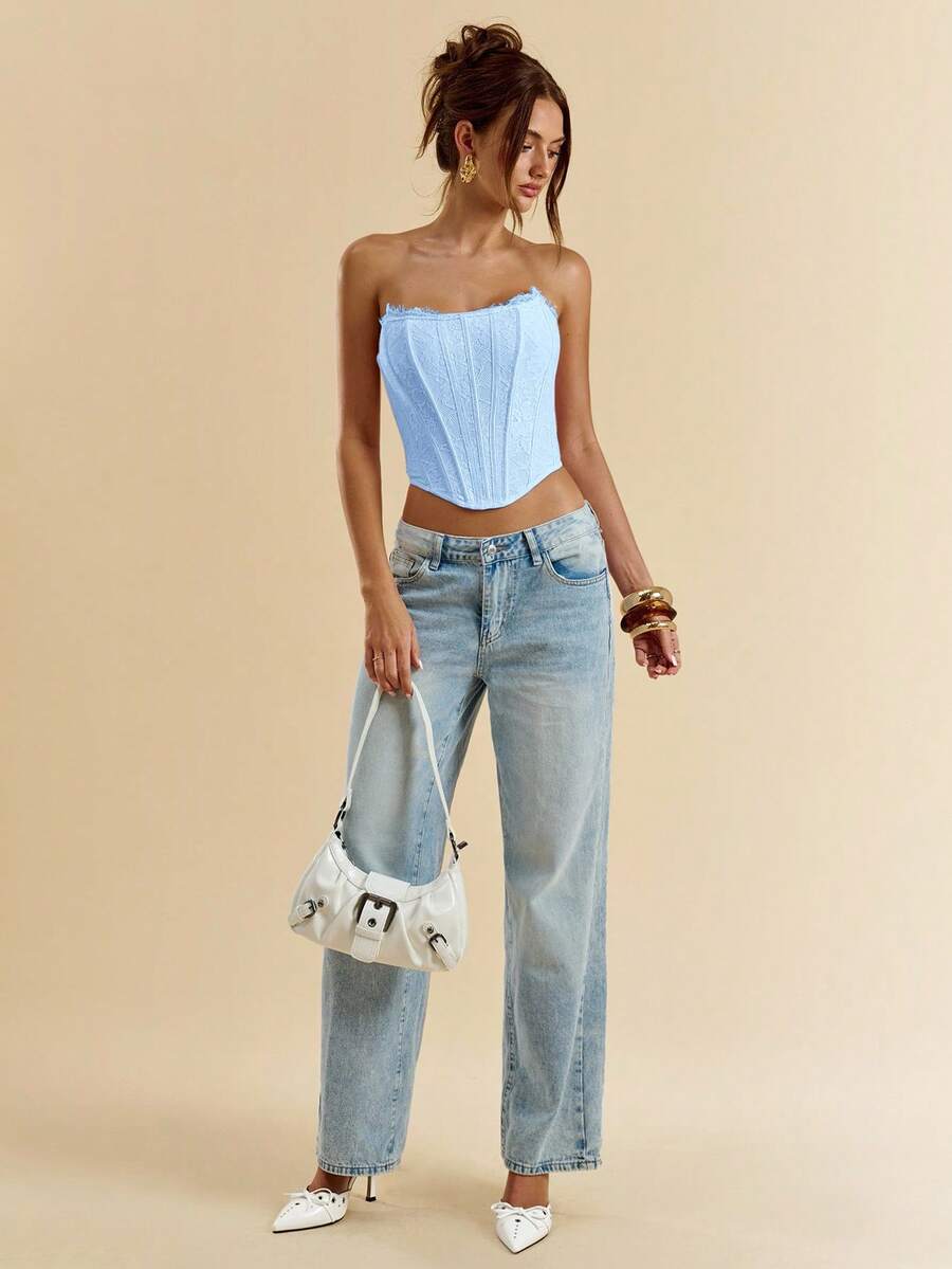 Women's strapless bustier crop top with contrast lace, lace-up detail, and an asymmetric hem in a slim-fit satin finish.