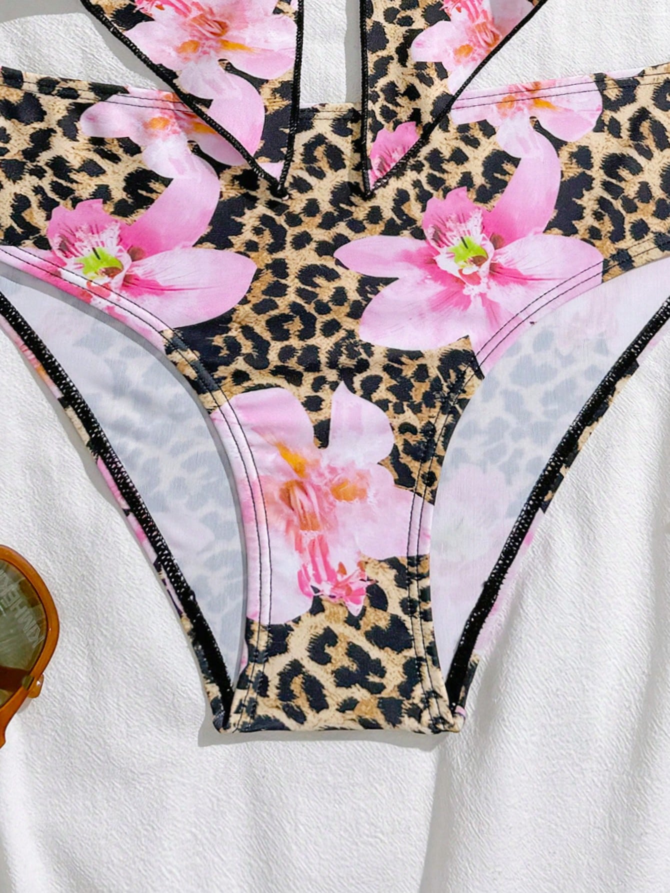 Tween girls two-piece tankini swimwear set with spaghetti straps, asymmetrical design, and 3D rose detail. Features a plant-pattern top and mid-waist bottoms in stretchy fabric for beach or pool wear.