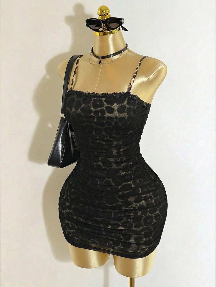 Black sleeveless mesh cami mini dress featuring spaghetti straps and slim fit design for women.
