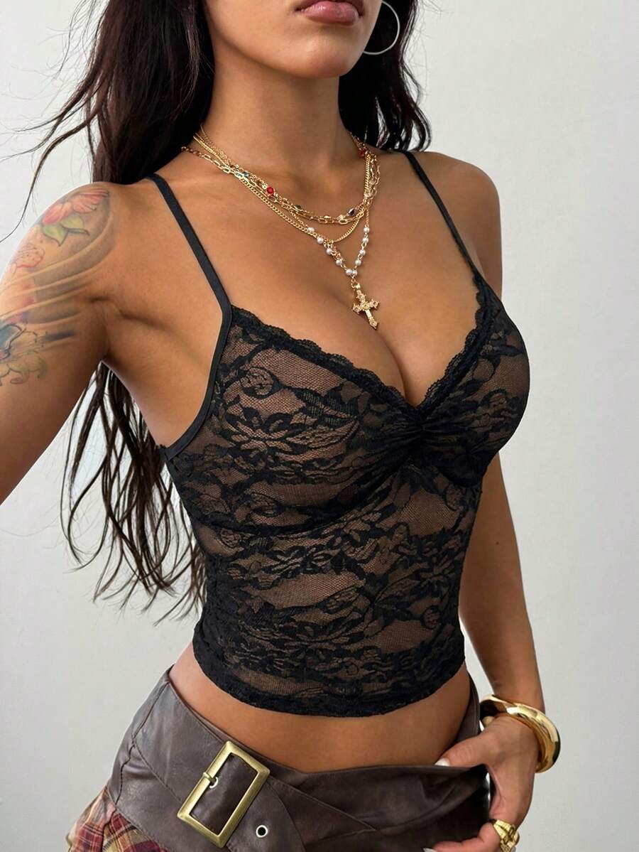 Women's black lace cami crop top featuring spaghetti straps, semi-sheer plant pattern fabric, and a backless design.